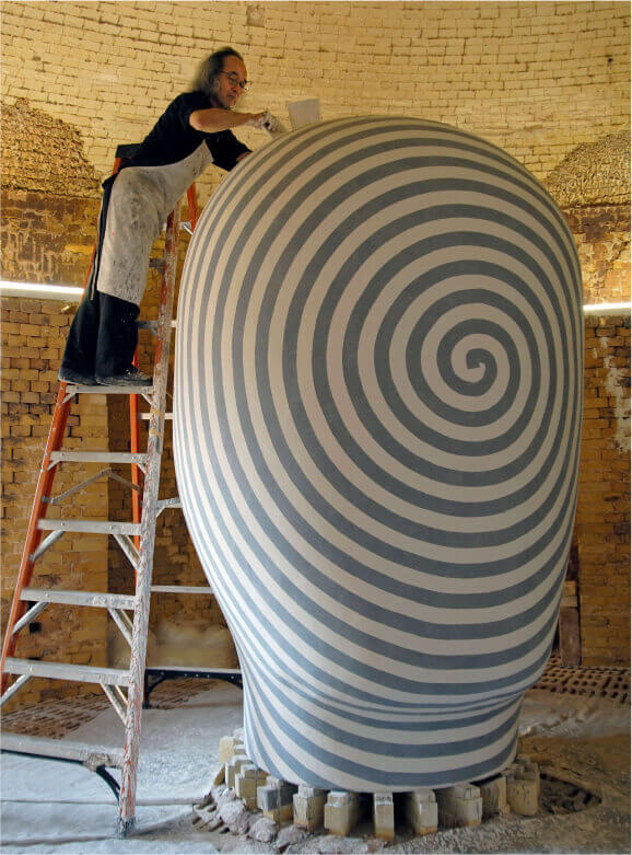 Glazing a head at Mission Clay Products in Pittsburg, KS, 2007.