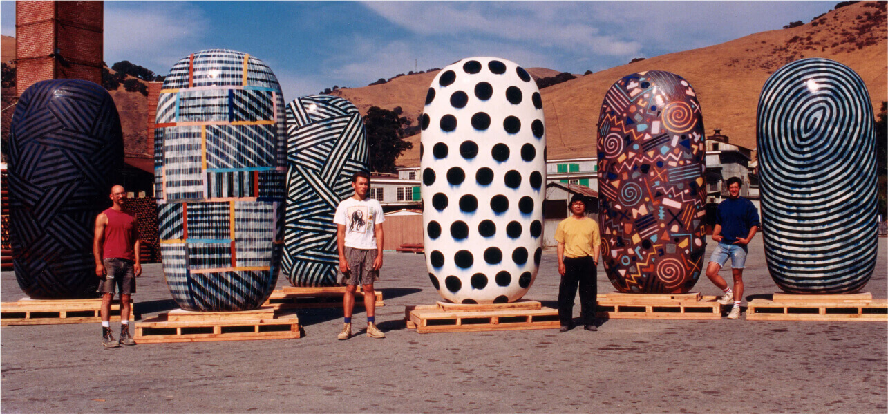 Kaneko with assistants in front of 12-foot-tall dangos at Mission Clay Products in Fremont, CA, 1994.