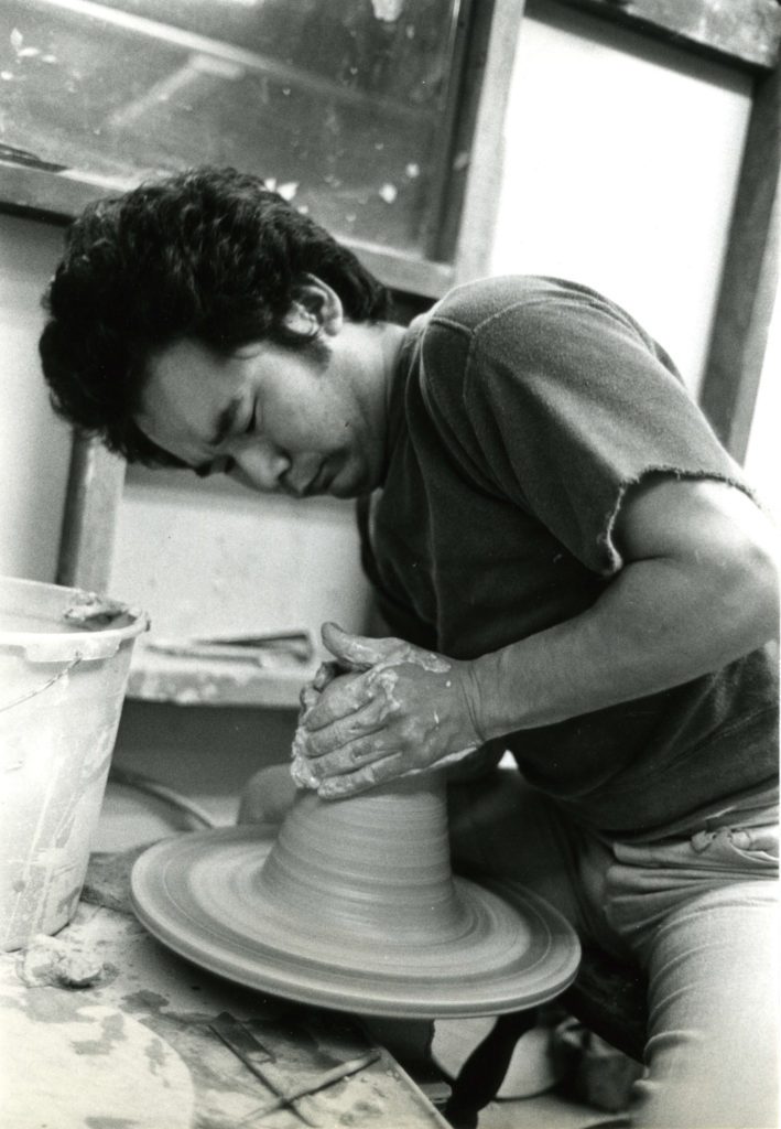 Jun Kaneko throwing a form on a pottery wheel,1968.