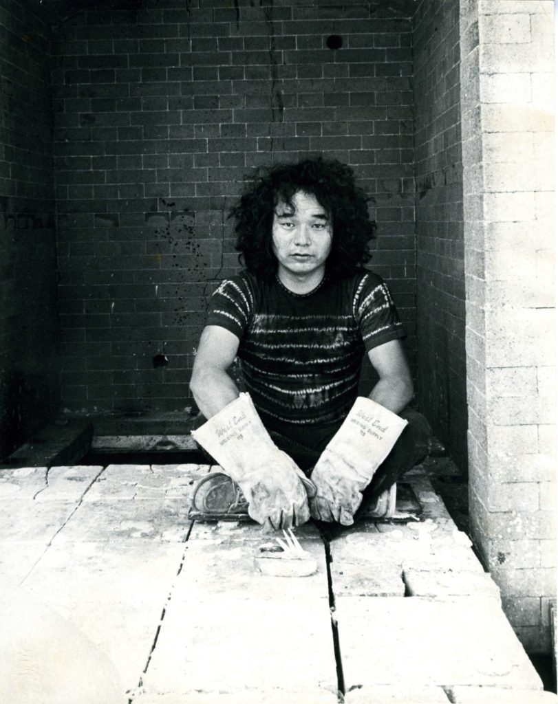 Jun Kaneko sitting in a kiln.