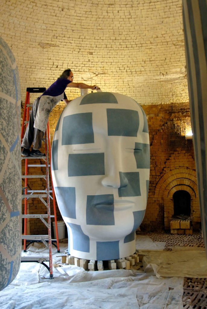 Jun Kaneko glazing a Head sculpture at Mission Clay Products in Pittsburg.